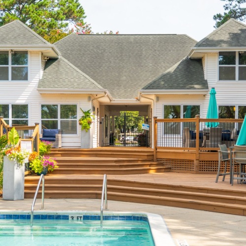 Back of leasing office with deck and pool