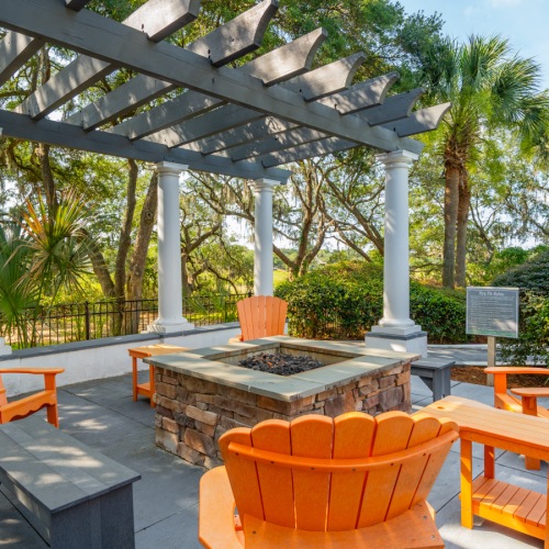 Adirondack chairs surrounding a fire pit