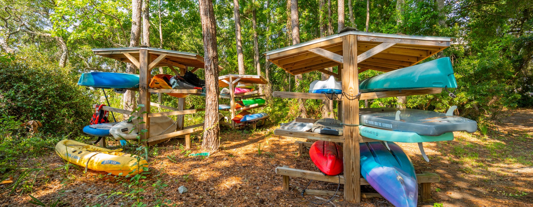 Wooded canoe storage area with canoes